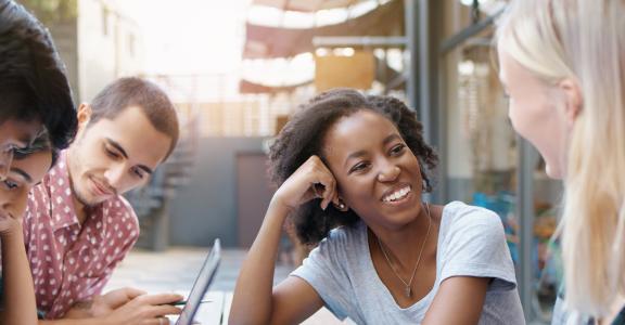 Students working together around a table.