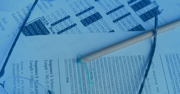 pencil with glasses and paper with dna sequences
